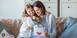 Mother and daughter holding gift