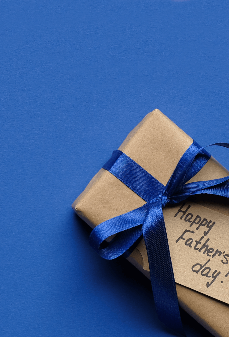 Father's Day gift on blue background with ribbon