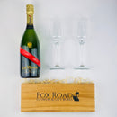 GH Mumm Champagne with flutes above a stained wooden gift box