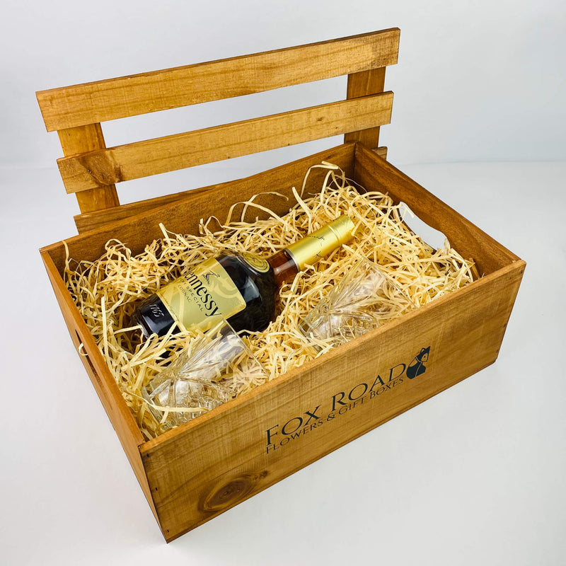 Hennessy Cognac gift box with glasses inside wooden crate.