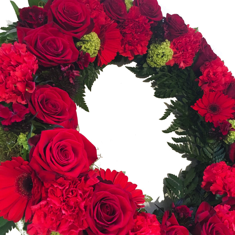 Funeral wreath with red flowers and ferns