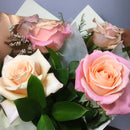 Close up photo of pink rose and peach rose