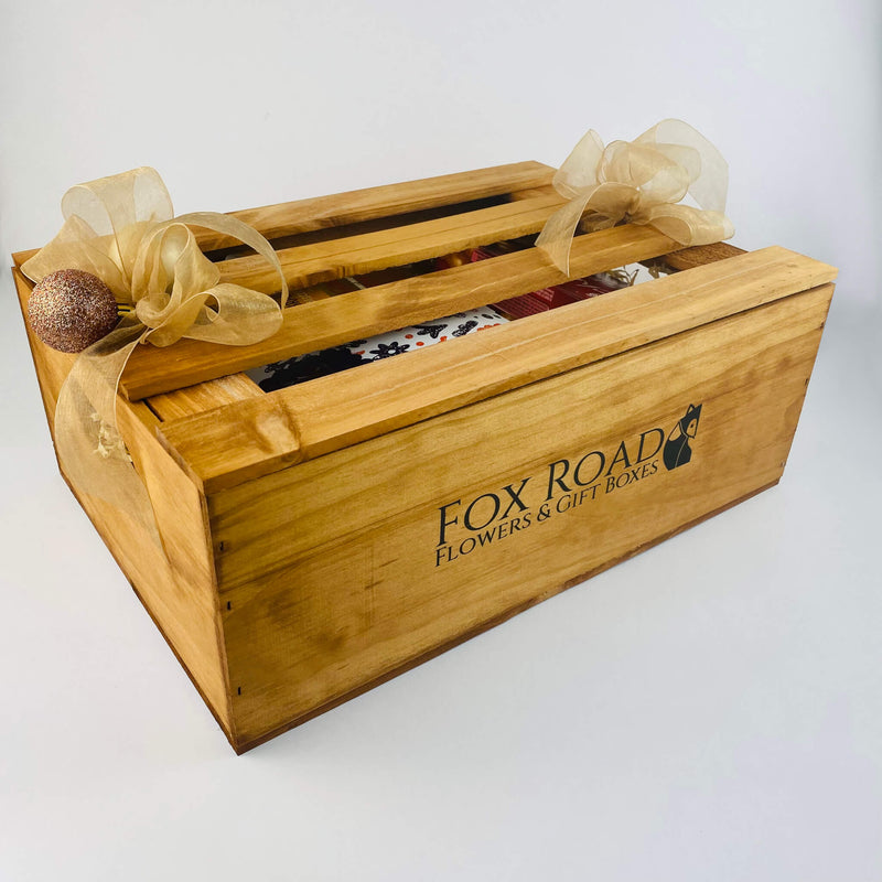 Wooden gift crate with Christmas snacks.