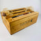 Wooden gift crate with ribbon and Christmas baubles.