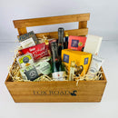 Wine and chocolates inside wooden gift crate