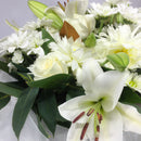 Close up of roses and lilies in a flower box