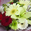 Close up view of bouquet showing gerberas and roses