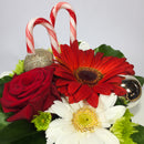 Candy canes and baubles with Christmas flowers
