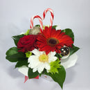 Christmas themed flower box with gerberas, candy canes and baubles