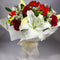 Bright lilies and red gerberas in a cardboard vase