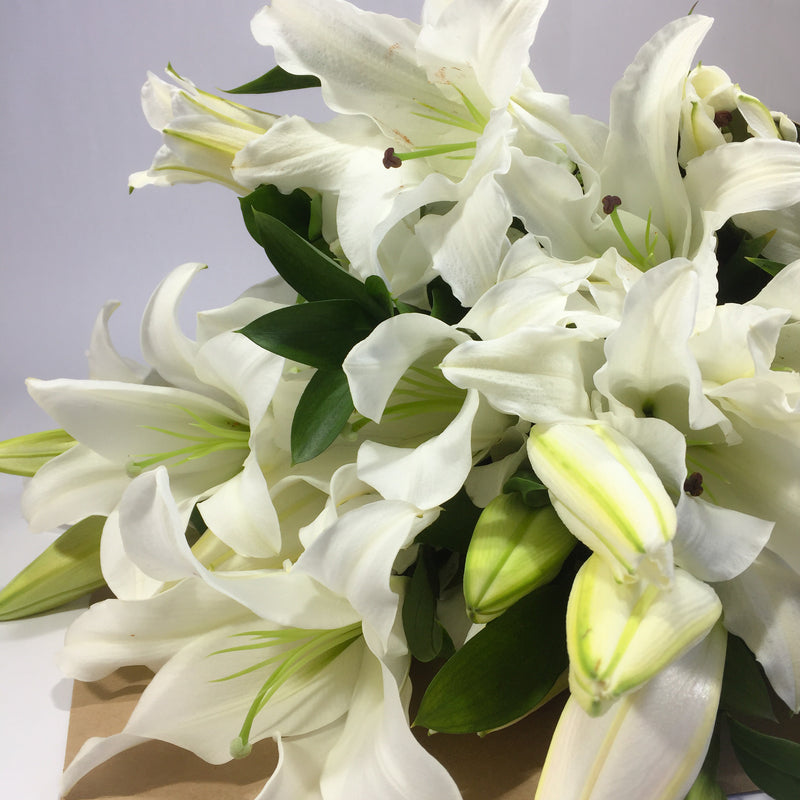 Ten lily stems in a casket spray