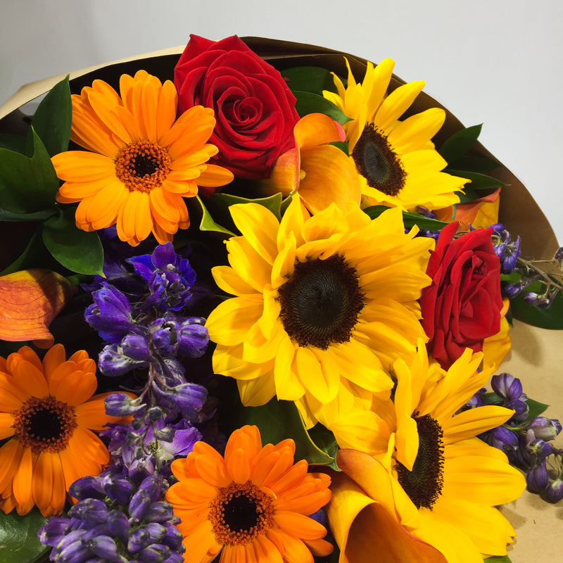 Porirua florist holding yellow Sunflowers and gerberas