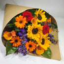 Bright sunflowers and red roses presented in a wrap