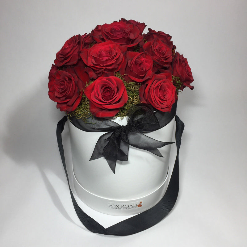 Red roses in a birthday flower hat box