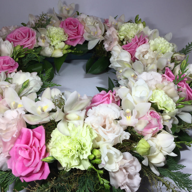 close up of wreath with funeral flowers