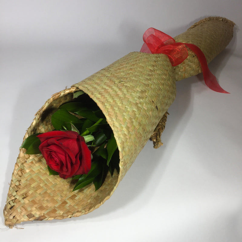 Red rose wrapped in traditional flax