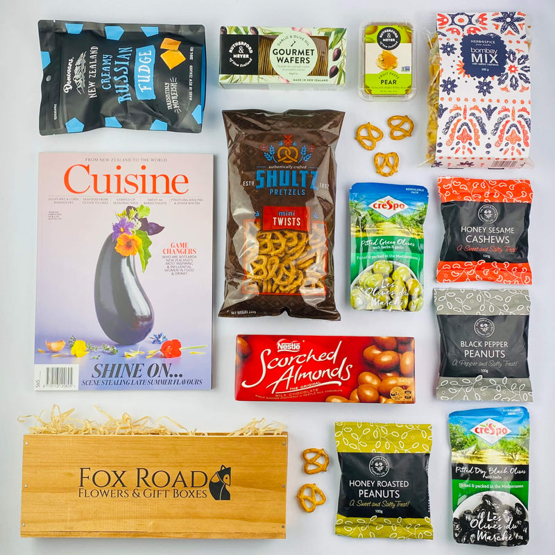 Cuisine Magazine with snacks by wooden gift box.
